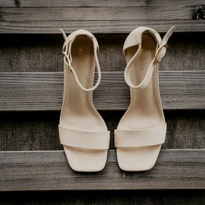 Cream block-heel sandals on wooden steps