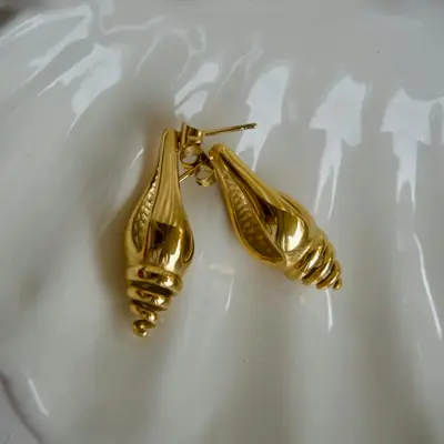 A pair of gold shell-shaped earrings