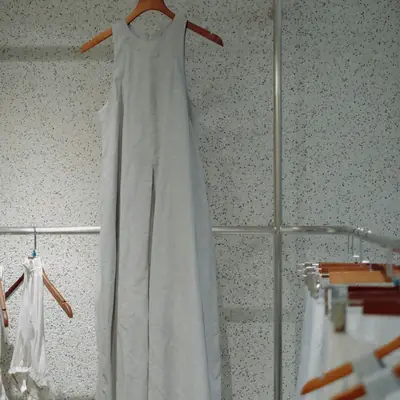 A long pale dress hanging on a hanger