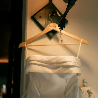 A satin slip dress on a wooden hanger