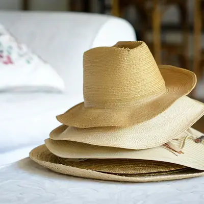 A stack of straw sun hats